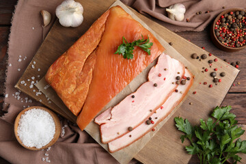 Flat lay composition with delicious smoked bacon on wooden table