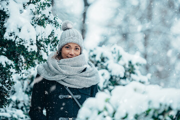 Beautiful young woman wearing scarf and a a hat on a cold winter day