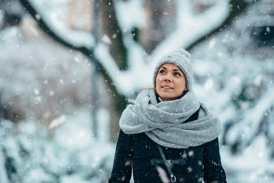 Beautiful young woman wearing scarf and a a hat on a cold winter day