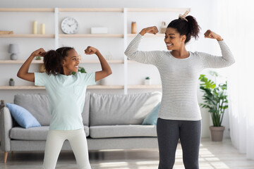 Athletic black mom and kid doing morning exercises together