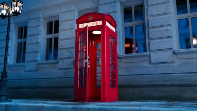 Red British phone booth with a hanging receiver on the wall. London symbol.