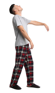 Somnambulist in pajamas on white background. Sleepwalking