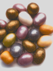 beautiful multicolored nut candy in chocolate colored glaze. aesthetic photos, fashionable colors....