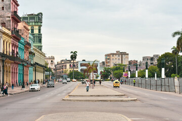 Fototapeta premium HAVANA, CUBA - AUGUST 26, 2017: Street scene with cocotaxi and colorful buildings in Old Havana, Cuba