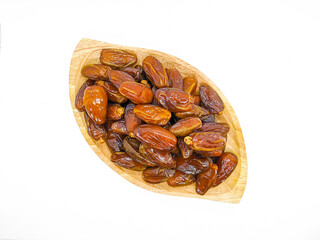 Fresh and healty premium honey tunisia dates (kurma tunisia) in a wooden bowl isolated on white background