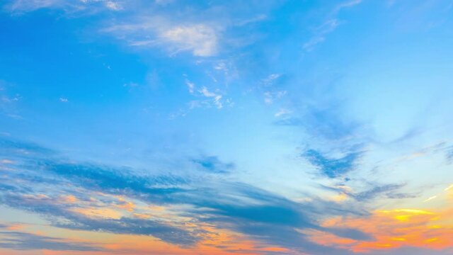 Colorful clouds are changing shapes on the blue sky at sunset.Sky sunset clouds time lapse.