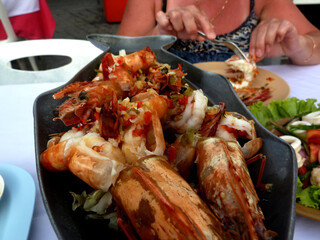 Delicious fresh cooked and grilled whole Lobster. Thai BBQ lobster, mookata ,Thai buffet restaurant, grilled seafood