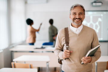 Portrait of happy mature student in the classroom looks at camera.