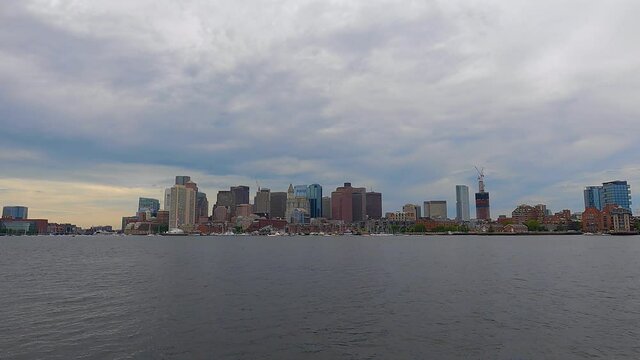 Boston modern financial district skyline and waterfront in a cloudy day, viewed from East Boston, Massachusetts MA, USA. 