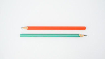 Pencils placed on white paper background with copy space for your image or text.