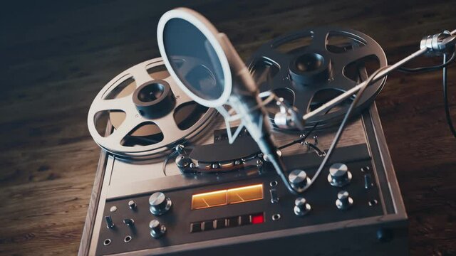 Vintage reel to reel tape machine with studio microphone and VU meter