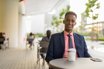 Fototapeta premium Portrait of successful young African businessman wearing suit and tie