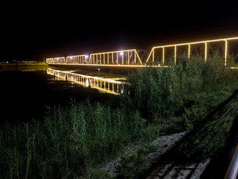 Night View of Euphrates River and The Old Green Bridge in Falluja, Iraq which Considered as a Corniche of the City.