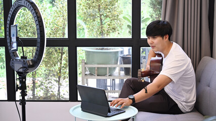 Happy young man recording video for social network.