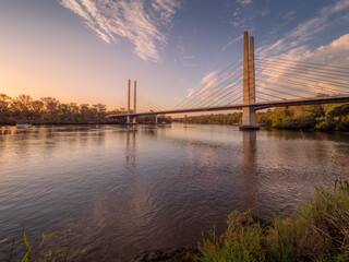 Fototapeta na wymiar Riverside Afternoon with Bridge