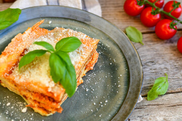   Delicious Home made keto diet  Lasagna bolognese  with  Lupin Flour, minced meat,tomato sauce and spinach  on a wooden rustic  background.Home made low carb italian meal
