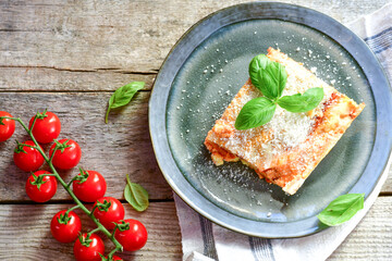   Delicious Home made  ketogenic Lasagna bolognese  with minced meat,tomato sauce and spinach  on a wooden rustic  background.Home made  keto diet italian meal