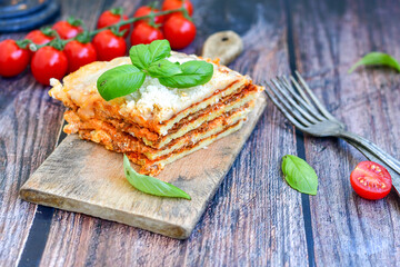   Delicious Home made  ketogenic Lasagna bolognese  with minced meat,tomato sauce and spinach  on a wooden rustic  background.Home made  keto diet italian meal