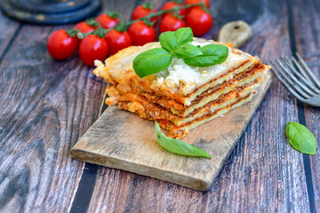   Delicious Home made  ketogenic Lasagna bolognese  with minced meat,tomato sauce and spinach  on a wooden rustic  background.Home made  keto diet italian meal