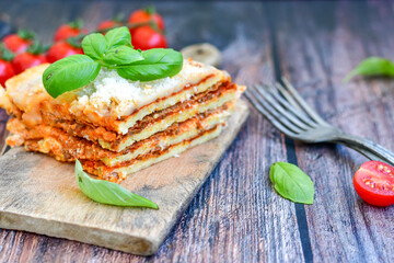   Delicious Home made  ketogenic Lasagna bolognese  with minced meat,tomato sauce and spinach  on a wooden rustic  background.Home made  keto diet italian meal