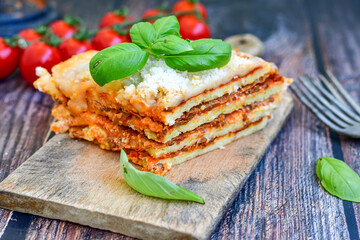   Delicious Home made  ketogenic Lasagna bolognese  with minced meat,tomato sauce and spinach  on a wooden rustic  background.Home made  keto diet italian meal