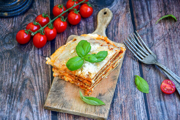   Delicious Home made  ketogenic Lasagna bolognese  with minced meat,tomato sauce and spinach  on a wooden rustic  background.Home made  keto diet italian meal
