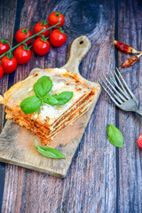   Delicious Home made  ketogenic Lasagna bolognese  with minced meat,tomato sauce and spinach  on a wooden rustic  background.Home made  keto diet italian meal