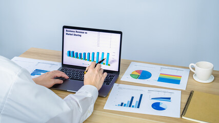 worker present business data graph on laptop in online meeting