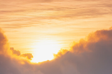 red and yellow sunlight of sun while sunrise or sunset with soft white cloud on sky for wallpaper or background