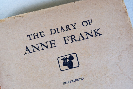 The title 'The Diary of Anne Frank' printed on the first pages of an old English translated book of Anne Frank's diary. Macro closeup view.