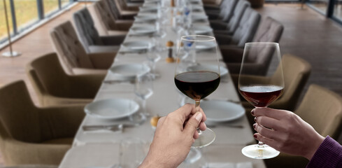 hand holding wine glass in vineyard