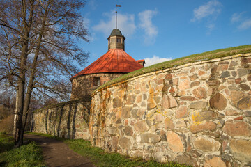 At the walls of the ancient fortress Korela on a sunny October evening. Priozersk, Russia