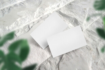 Clean minimal business card mockup on white stone floor and light shadow