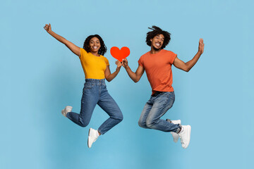 Fototapeta na wymiar Happy african american man and woman with heart-shaped red card