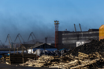 Fototapeta premium Coal transshipment port in the city of Nakhodka. Dirty coal handling facilities. Sea coal port.