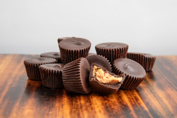 Chocolate peanut butter cups on a dark wooden table