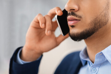 Business Call. Closeup Shot Of Young Middle Eastern Man Talking On Cellphone