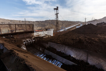 Extraction and processing of coal. Conveyor with coal in the open air.