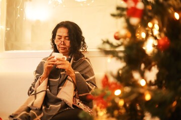 Woman drinking coffee at home.