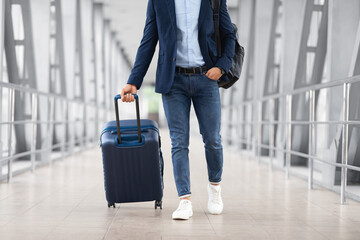 Unrecognizable Man With Hand Luggage Suitcase Walking At Airport Terminal, Cropped Shot