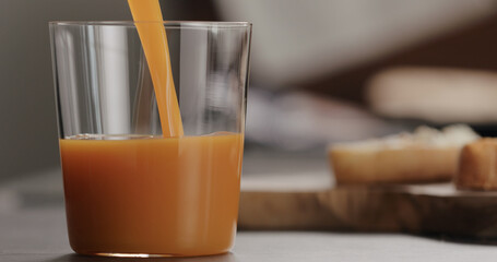 pour pumpkin juice into tumbler glass with copy space