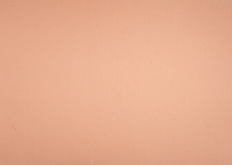 Textured pastel pink paper background. Blank cream surface.
