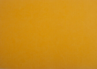 Yellow textured paper background. Bright yellow decorative surface.