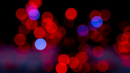 Blurred red and blue Christmas lights. Christmas decoration with lights glowing. Abstract Christmas background with defocused lights