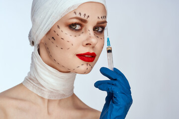 woman in blue gloves syringe in hands contour on the face lifting isolated background