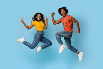 Fototapeta na wymiar Carefree african american couple fooling on blue
