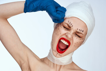 portrait of a woman in blue gloves syringe in hands contour on the face lifting light background