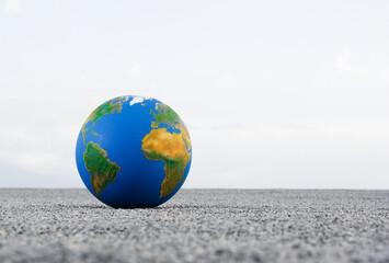 Earth Globe on Sand or Road. World or Planet Globe on Sands Outdoor, Selective Focus