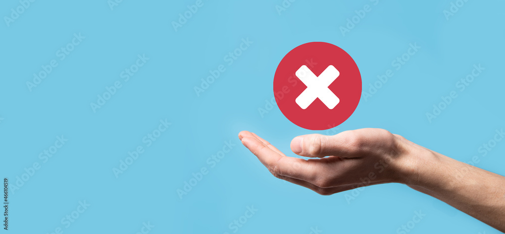 Fototapete hand holds icon,cancellation symbol,cancel icon.cross mark flat red icon.round x mark.cancel button.
