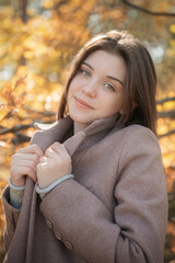 Young teenager girl in the autumn forest